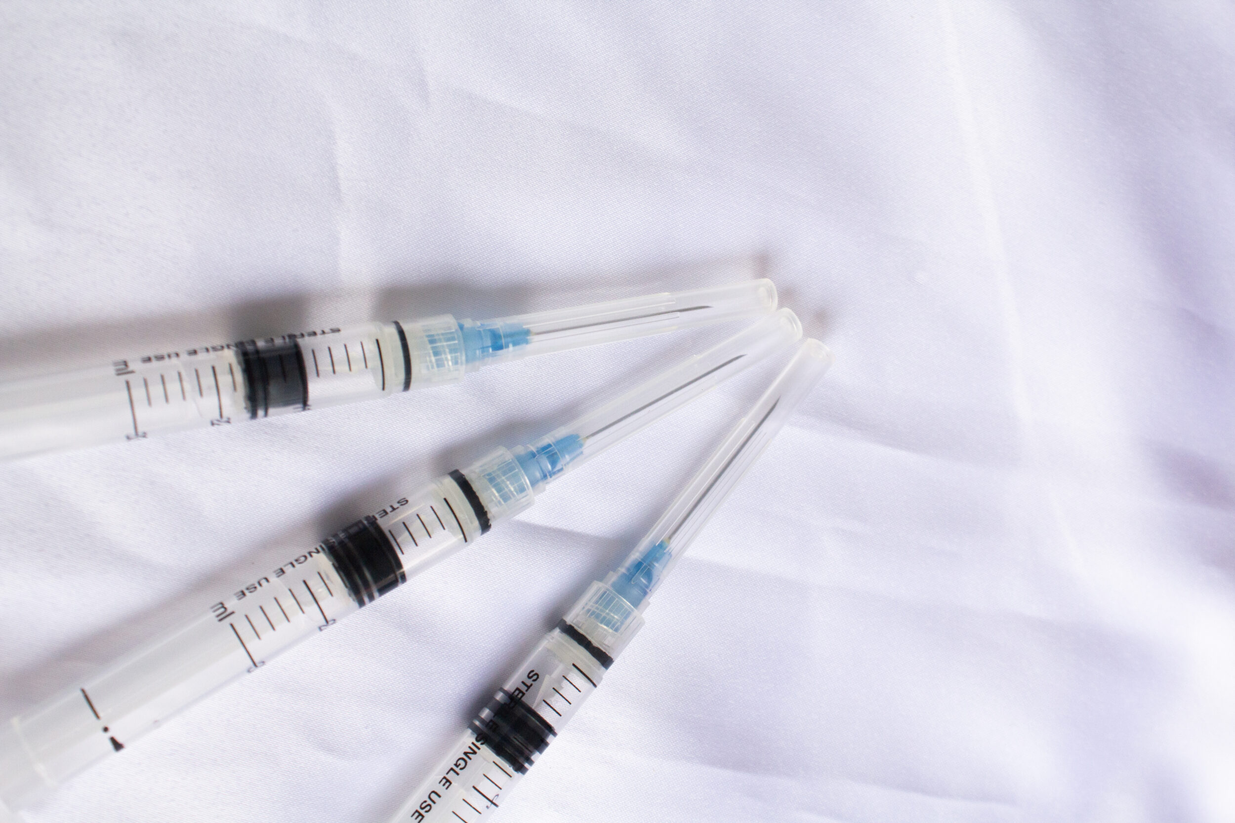 Medical injection syringe with clear measurements and sharp needle tip. Healthcare equipment concept