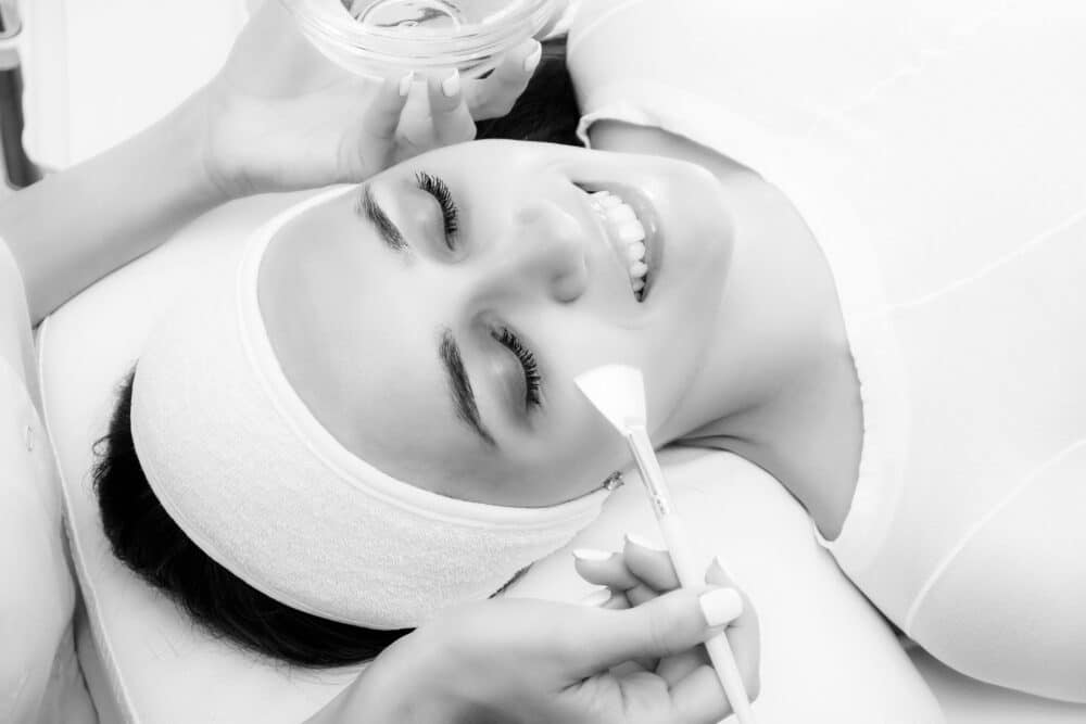 Face peeling at the beautician. Facial treatments. Photo chemical, glycolic, almond peeling.