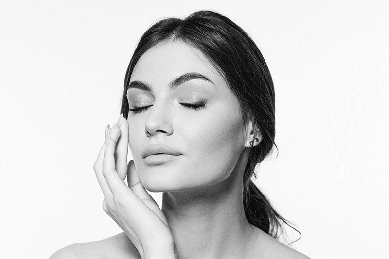 Beautiful brunette woman in studio flawless skin