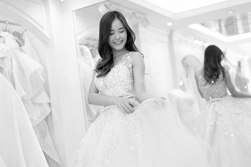 Asia young is smiling while choosing wedding dress in modern wed