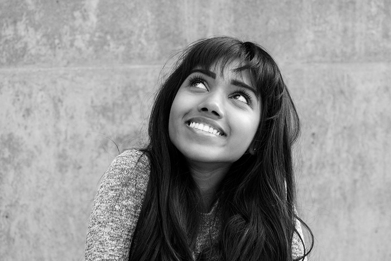 Close up young Indian woman smiling and looking up